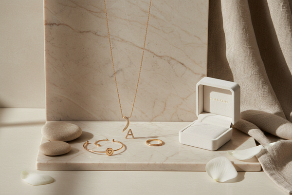 erstelle mir ein ästhetisches bild für personalisierten schmuck mit beige und marmor optik hintergrund